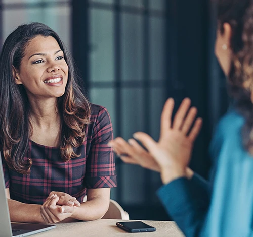 Two colleagues in discussion during a business meeting